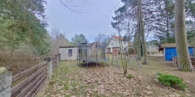 Blick vom Waldrand über das Grundstück - Gepflegtes Einfamilienhaus mit Nebengelass und Garage am Wald in Borkheide